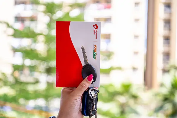stock image Delhi, India - 27th Mar 2024: Woman holding Airtel Payment bank Fastag with car key showing the new payment method from NHAI national highway authority of India for Toll