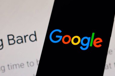 February 9, 2023, Brazil. In this photo illustration, the Google logo is displayed on a smartphone screen, in the background, the page of the new artificial intelligence (AI) tool called Bard
