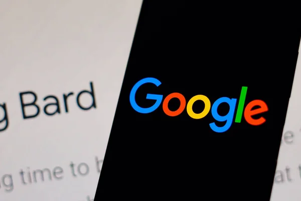 stock image February 9, 2023, Brazil. In this photo illustration, the Google logo is displayed on a smartphone screen, in the background, the page of the new artificial intelligence (AI) tool called Bard