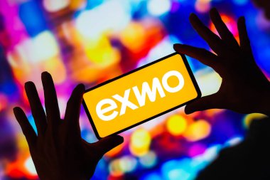 February 27, 2023, Brazil. In this photo illustration, the EXMO logo seen displayed on a smartphone