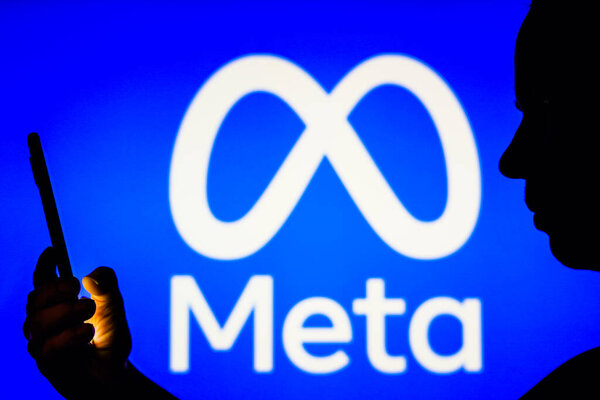 April 6, 2023, Brazil. In this photo illustration, a woman's silhouette holds a smartphone with the Meta Platforms, Inc. logo in the background