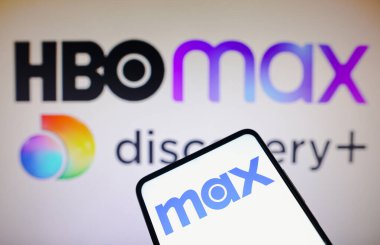 April 13, 2023, Brazil. In this photo illustration, the Max logo is seen displayed on a smartphone and the HBO Max and Discovery logo on the background