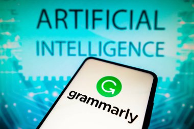 April 19, 2023, Brazil. In this photo illustration, the Grammarly logo is displayed on a smartphone screen and in the background the text artificial intelligence clipart