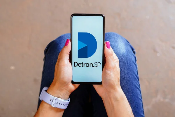 stock image August 30, 2023, Brazil. In this photo illustration, the Detran SP logo is displayed on a smartphone screen