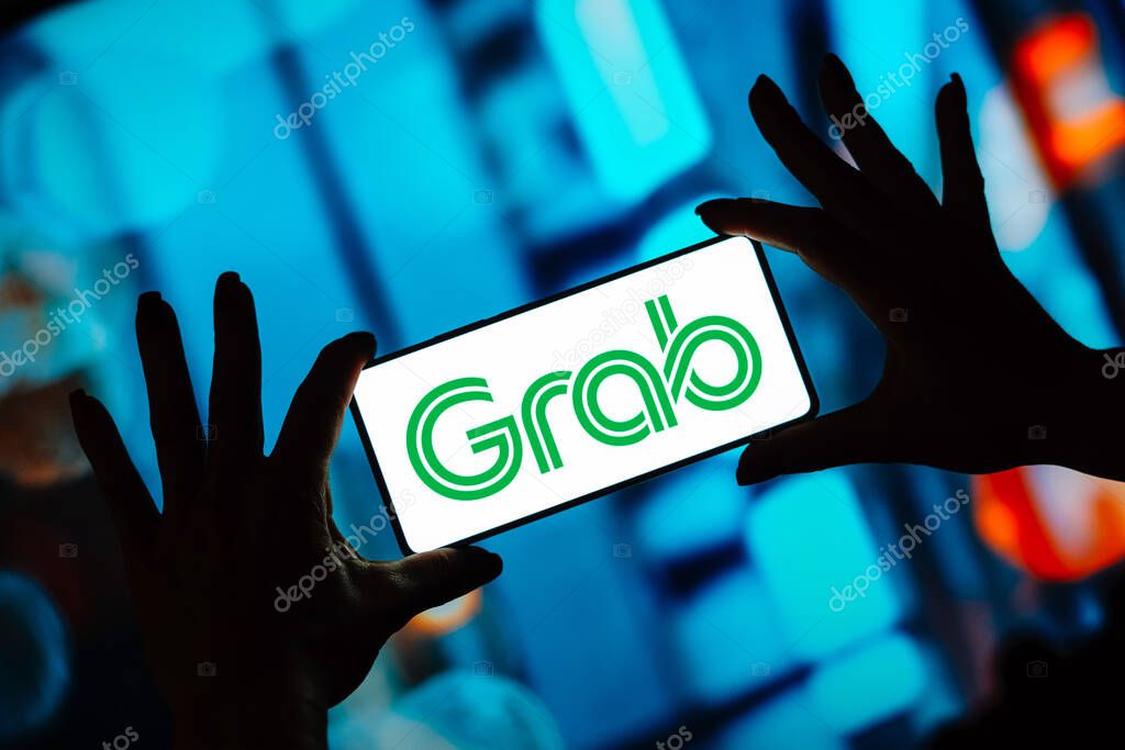 October 2, 2023, Brazil. In this photo illustration, the Grab logo is displayed on a smartphone screen