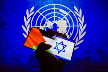 October 12, 2023, Brazil. In this photo illustration, the flag of Israel and Palestine is displayed on a smartphone screen and in the background the flag of the United Nations (UN) clipart