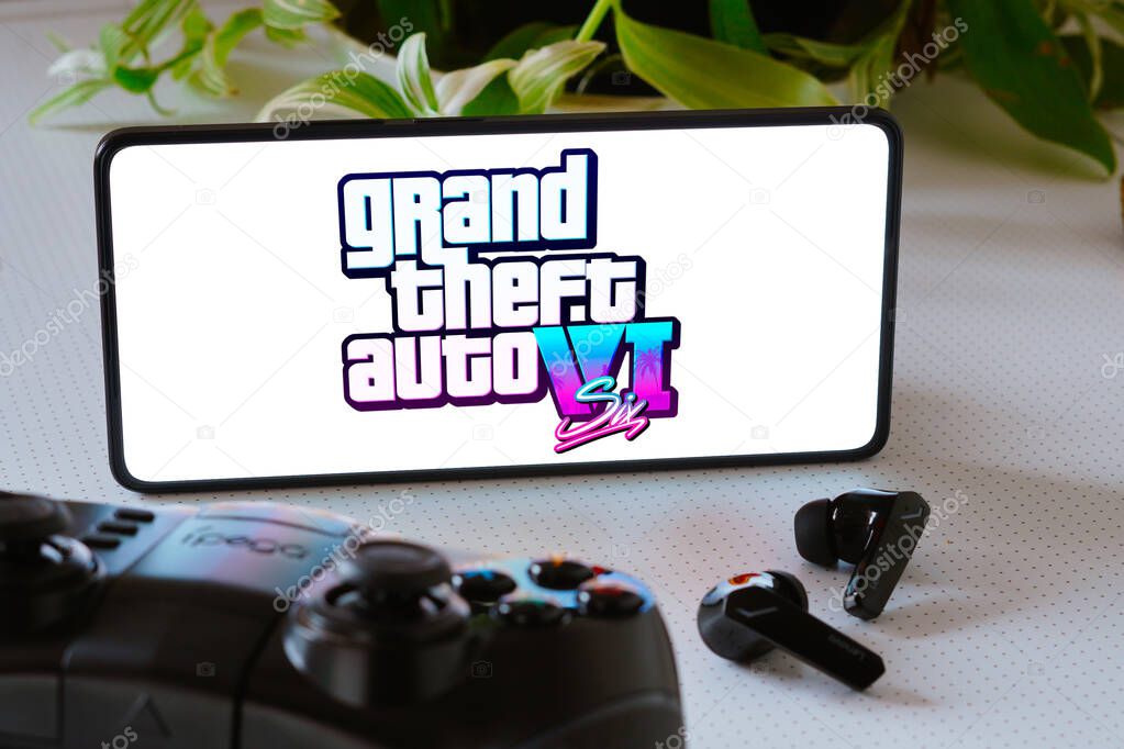 December 5, 2023, Brazil. In this photo illustration, the Grand Theft Auto VI (GTA 6) game logo is displayed on a smartphone screen, next to a gamepad and headphones