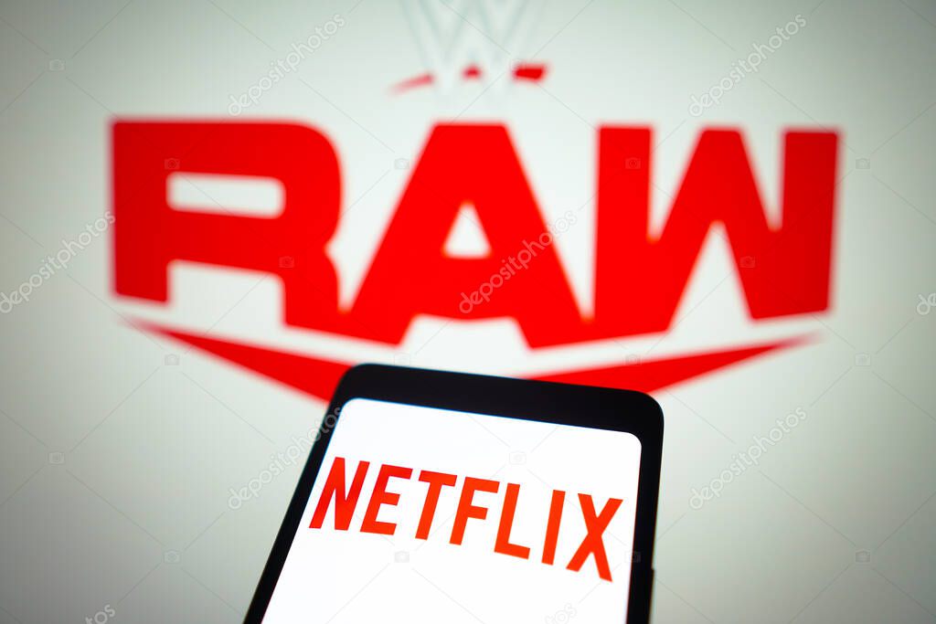 January 23, 2024, Brazil. In this photo illustration, the Netflix logo is displayed on a smartphone screen and WWE Raw logo in the background