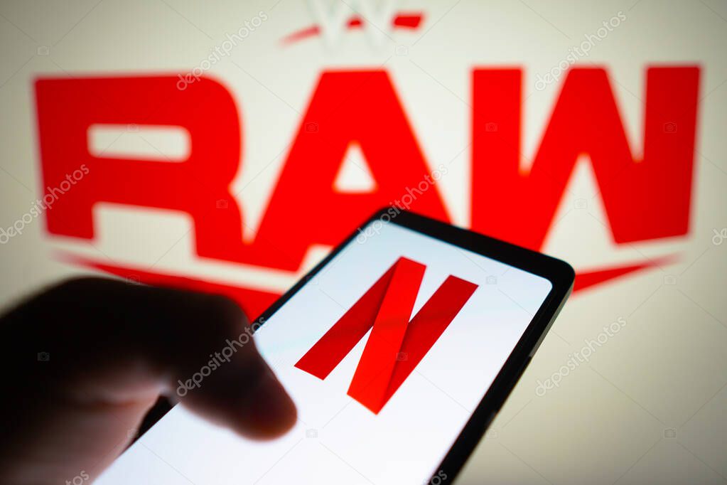 January 23, 2024, Brazil. In this photo illustration, the Netflix logo is displayed on a smartphone screen and WWE Raw logo in the background