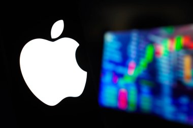 15 Mart 2024, Brezilya. Bu fotoğraf illüstrasyonunda, Apple Inc. logosu arka planda borsanın grafik temsili ile akıllı telefon ekranında gösterilir.