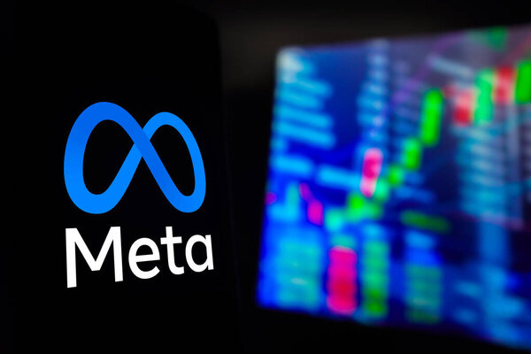 March 15, 2024, Brazil. In this photo illustration, the Meta Platforms, Inc. logo is displayed on a smartphone screen, with graphic representation of the stock market in the background