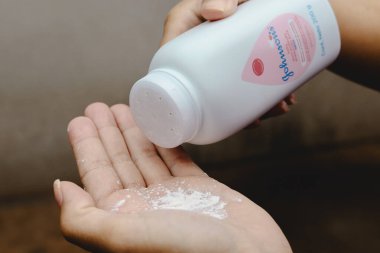 July 8, 2024, Paraguay. In this photo illustration, a person uses Johnson Johnson baby powder on their hands. clipart