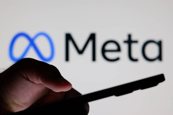July 10, 2024, Paraguay. In this photo illustration, the Meta Platforms, Inc. logo seen in the background of a silhouette people holding a smartphone