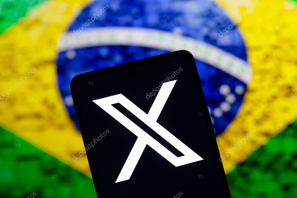 August 17, 2024, Paraguay. In this photo illustration, the X (Twitter) logo is displayed on a smartphone screen and the flag of Brazil in the background. Social network X announces that it will close its office in Brazil