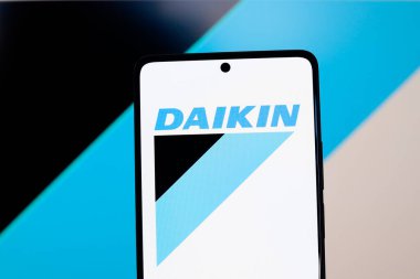 August 26, 2024, Paraguay. In this photo illustration, the Daikin Industries logo is displayed on a smartphone and in the background clipart