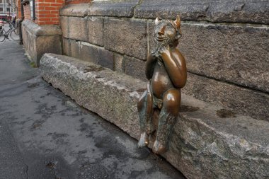 Lubeck, Germany - Jan 10, 2020: Devil on the Devil Stone Sculpture in front of St. Mary Church (Marienkirche) - Lubeck, Germany