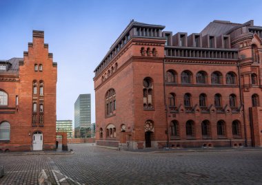 Brick buildings at Speicherstadt warehouse district with Modern Buildings of Dovenfleet on background - Hamburg, Germany