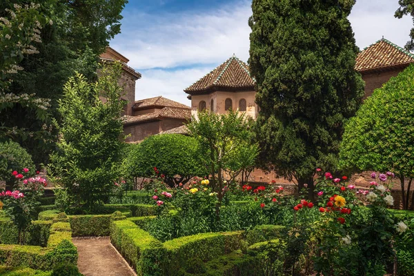 stock image Granada, Spain - May 24, 2019: Gardens of El Partal with tower of Hall of the Abencerrajes at Nasrid Palaces of Alhambra - Granada, Andalusia, Spain