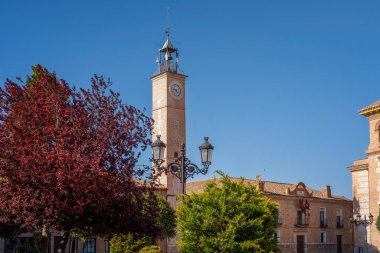 Clock Tower (Torre del Reloj) and Consuegra City Hall at Plaza de Espana Square - Consuegra, Castilla-La Mancha, Spain clipart