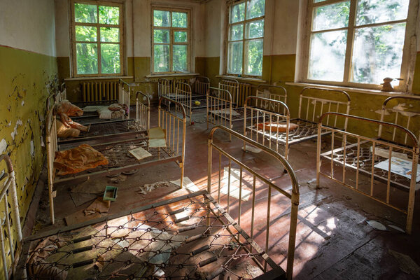 Chernobyl, Ukraine - Aug 06, 2019: Abandoned Kindergarten with Cradles - Kopachi Village, Chernobyl Exclusion Zone, Ukraine