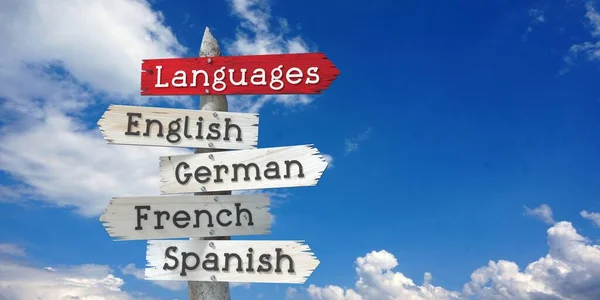 Languages Concept English German French Spanish Wooden Signpost Five Arrows — Stock Photo, Image
