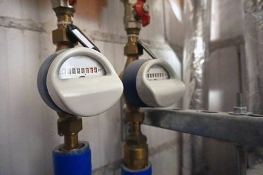 Hot and cold water flow meters installed on pipes