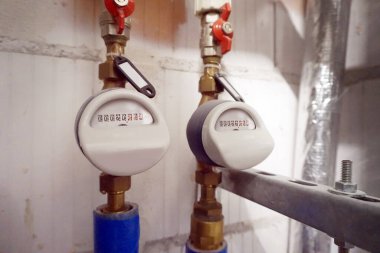 Hot and cold water flow meters installed on pipes