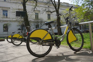 Lodz, Poland - May 8th, 2022 - Many yellow and grey city bikes standing in a row - rental service