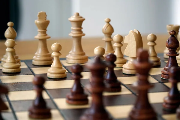 stock image Black and white chess pieces on a board - selective focus
