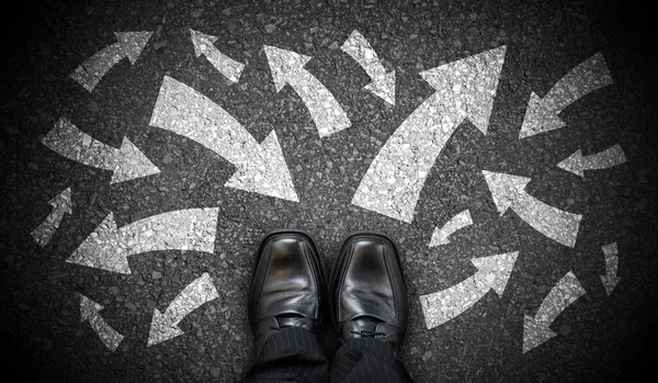 stock image Black business shoes and many chalky arrows in various directions - chaos concept