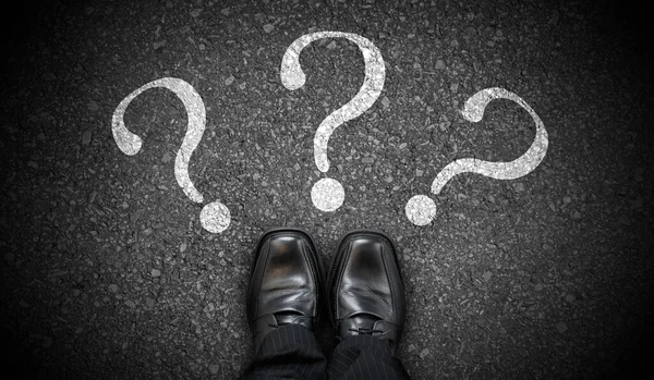 stock image Black business shoes and three question marks - problem concept