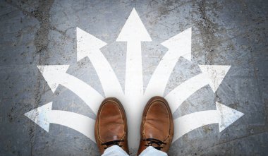 Kahverengi deri ayakkabılar ve asfalt üzerinde tebeşir gibi oklar - karar verme konsepti