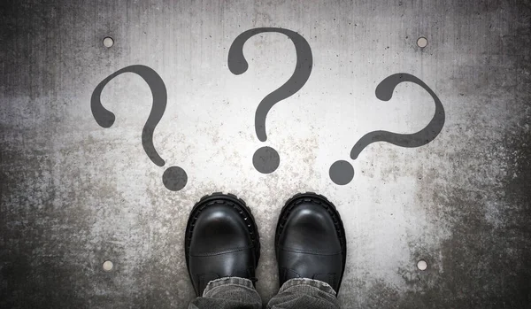 stock image Heavy black leather boots and three question marks - problem concept