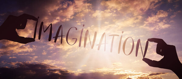 Imagination - human hands holding black silhouette word