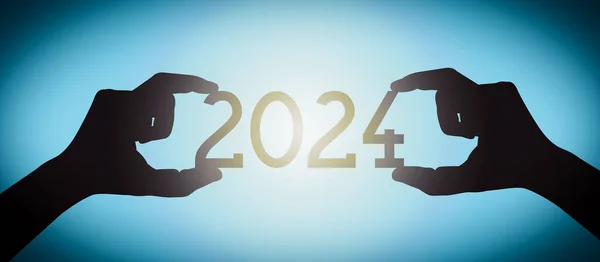 2024年 黒のシルエット年番号 グラデーションの背景を持つ人間の手 — ストック写真