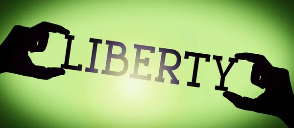 Liberty 黒いシルエットの単語 グラデーションの背景を持つ人間の手 — ストック写真