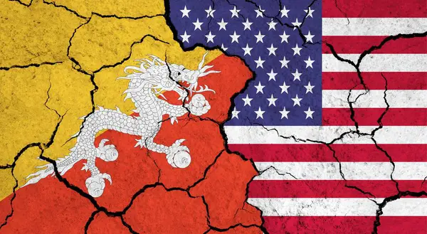 Flags of Bhutan and USA on cracked surface - politics, relationship concept