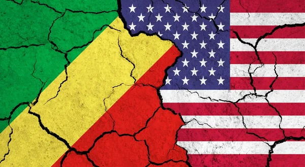 Flags of Congo and USA on cracked surface - politics, relationship concept