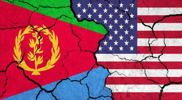 Flags of Eritrea and USA on cracked surface - politics, relationship concept
