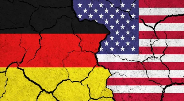 Flags of Germany and USA on cracked surface - politics, relationship concept