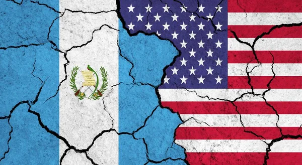 Flags of Guatemala and USA on cracked surface - politics, relationship concept