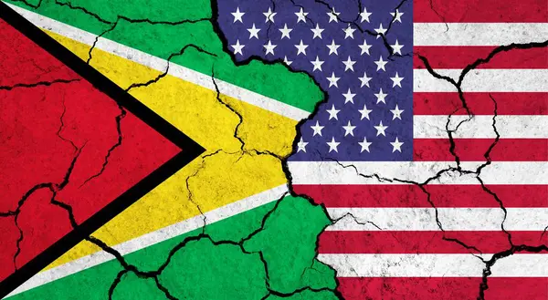 Flags of Guyana and USA on cracked surface - politics, relationship concept