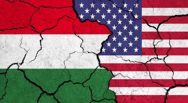 Flags of Hungary and USA on cracked surface - politics, relationship concept