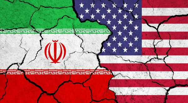 Flags of Iran and USA on cracked surface - politics, relationship concept