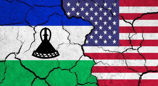 Flags of Lesotho and USA on cracked surface - politics, relationship concept