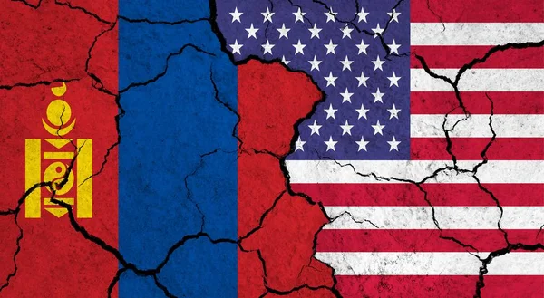 Flags of Mongolia and USA on cracked surface - politics, relationship concept