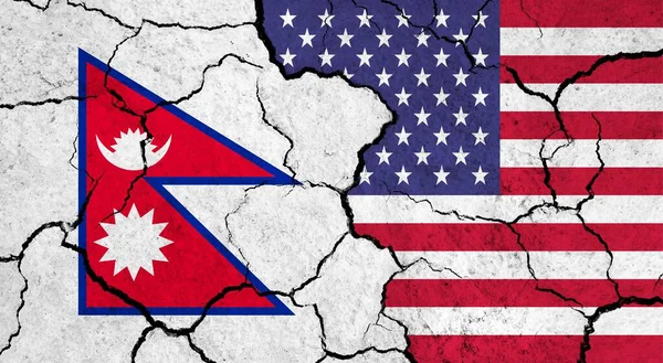 Flags of Nepal and USA on cracked surface - politics, relationship concept