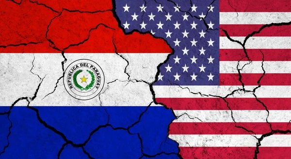 Flags of Paraguay and USA on cracked surface - politics, relationship concept