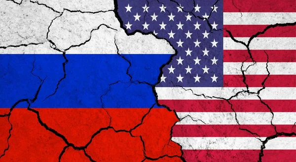 Flags of Russia and USA on cracked surface - politics, relationship concept
