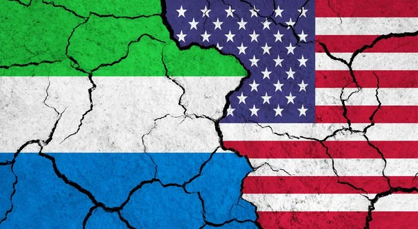Flags of Sierra Leone and USA on cracked surface - politics, relationship concept